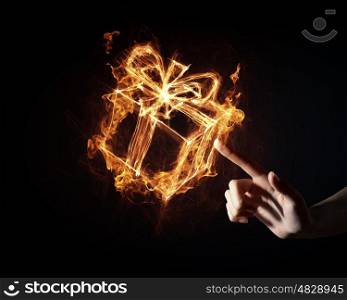 Gift box icon. Glowing fire gift box icon on dark background