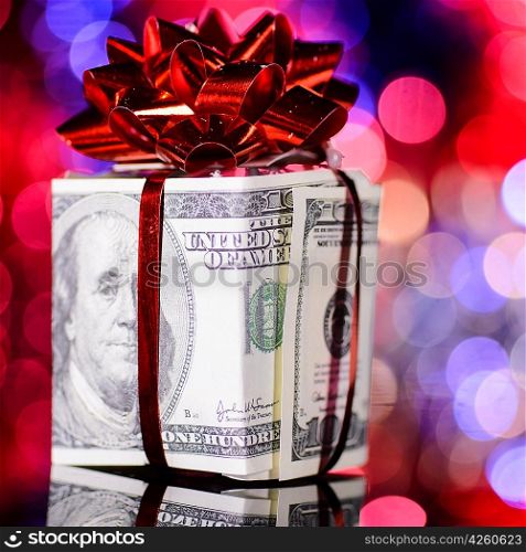 gift box made of dollars on blurred background