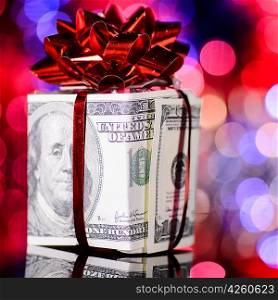 gift box made of dollars on blurred background