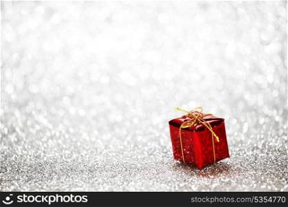 Gift box on glitter silver background