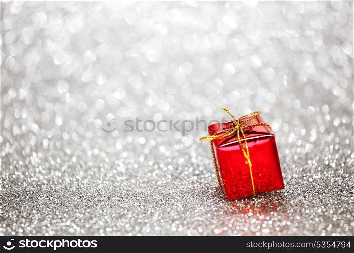 Gift box on glitter silver background
