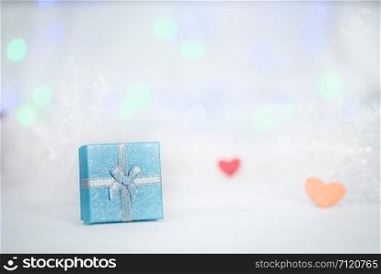 gift box on the white fur, bokeh background, with copy space for season greeting, Merry Christmas or Happy New Year.AF point selection,blurred.