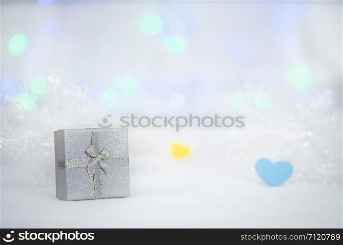 gift box on the white fur, bokeh background, with copy space for season greeting, Merry Christmas or Happy New Year.AF point selection,blurred.