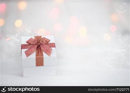 gift box on the white fur, bokeh background, with copy space for season greeting, Happy New Year, AF point selection, blurred.