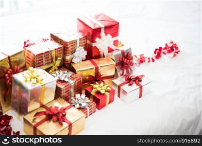 Gift box on white bed sheet background for surprise Children in New year or Xmas party festival. Relaxing holiday and Object concept. Christmas party event and Happy new year theme. Decorate property