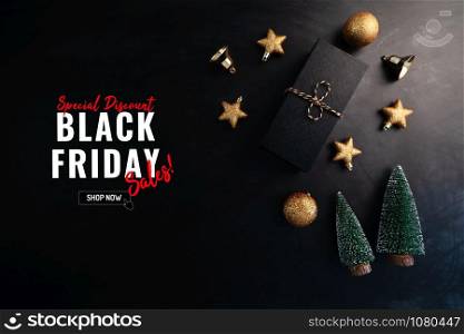gift box with Christmas decoration for Black Friday Sale concept on black background