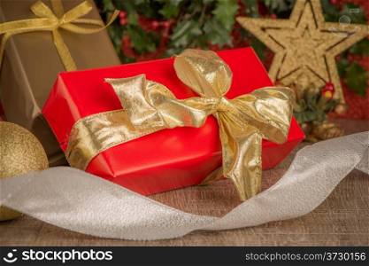 Gift box with christmas elements on wooden background