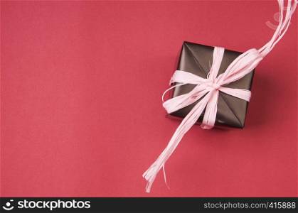 gift box with pink bows, and ribbons on a colored background