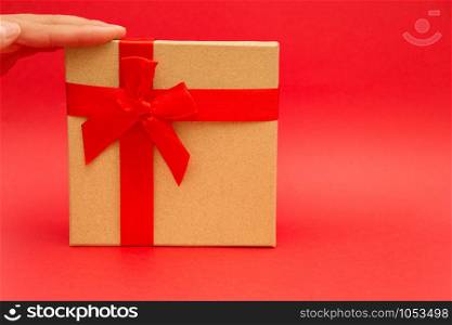 gift box with red ribbon on red background with copy space.. gift box with red ribbon on red background with copy space