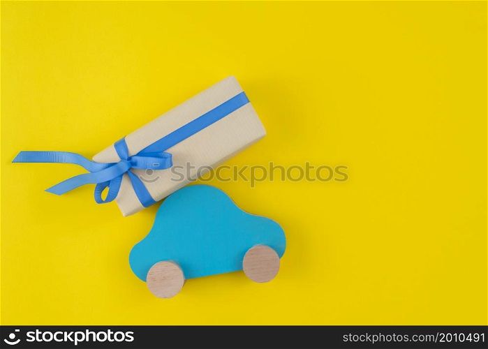 gift box with toy car yellow table