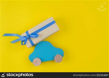 gift box with toy car yellow table