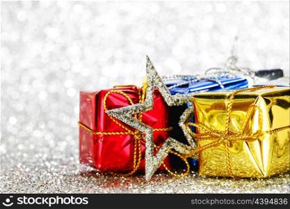 Gift boxes and decoration on glitter silver background