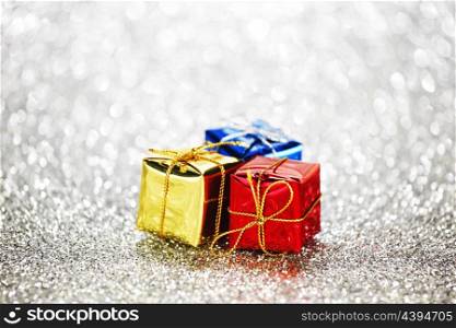 Gift boxes on glitter silver background