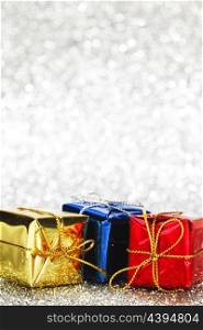 Gift boxes on glitter silver background