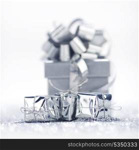 Gift boxes on glitter silver background with white copy space