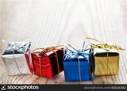 Gift Boxes. Small gift boxes on wooden background macro close-up
