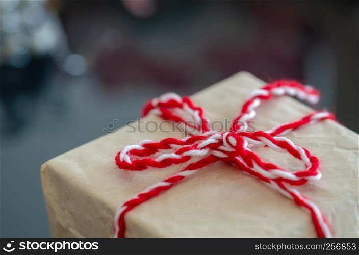 Gift boxes with a white bow against a background bokeh of twinkling New Year gift. Christmas gift. Christmas background with gift box Christmastime celebration