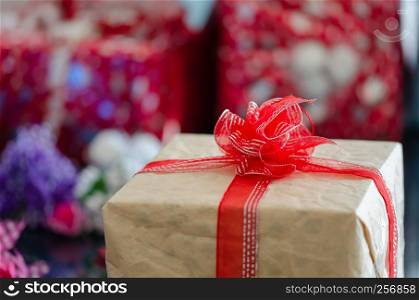 Gift boxes with a white bow against a background bokeh of twinkling New Year gift. Christmas gift. Christmas background with gift box Christmastime celebration