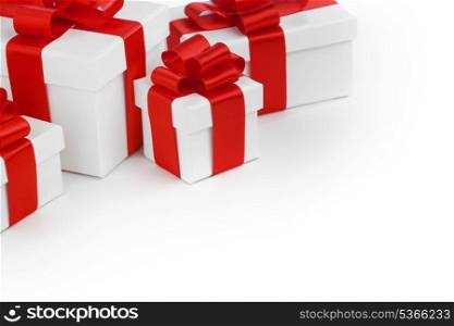 Gift boxes with red ribbon bows on white background