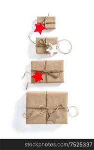 Gift boxes with star shaped paper tag on white. Holidays background