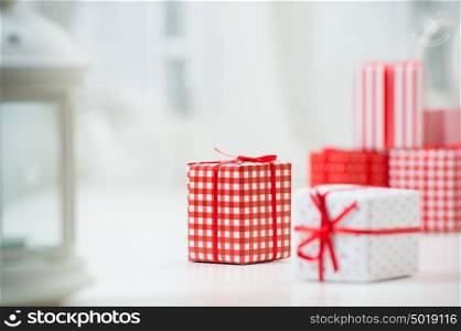 Gift boxes with xmas presents wrapped in red paper with ornament. Lots of copyspace