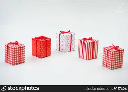 Gift boxes with xmas presents wrapped in red paper with ornament on white background