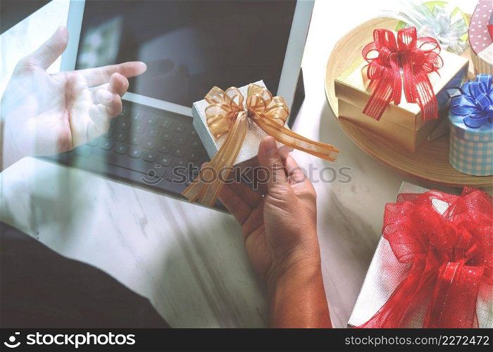 Gift giving Creative Hand choosing and hand with gift. Gift delivery, surprise,tablet computer docking smart keyboard smart phone on mable desk,vintage film effect
