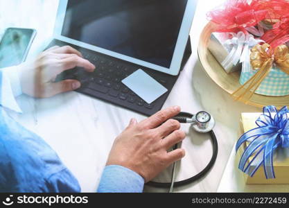 Gift giving,medical doctor Hand with credit card and hand with gift. Gift delivery, surprise,tablet computer docking smart keyboard smart phone on mable desk,filter film effect