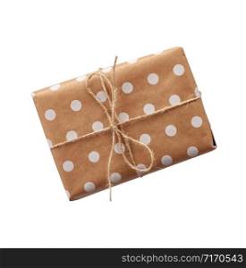 gift in box wrapped in brown kraft paper and tied with rope on a white background. Festive concept