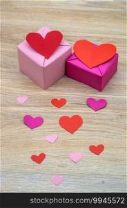 gift in pink packaging, red hearts in honor of February 14, valentine"s day, a birthday gift, to give a gift. valentine"s day, gift in pink packaging, red hearts in honor of February 14, a birthday gift, to give a gift
