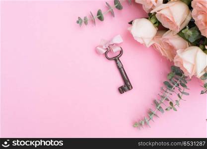 gift or present box and flowers. gift or present box and flowers on pink table with flowers and key, flat lay frame