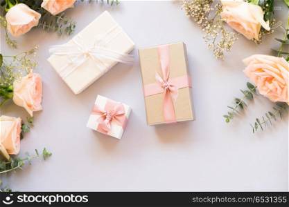 gift or present box and flowers. gift or present box and flowers on blue table from above