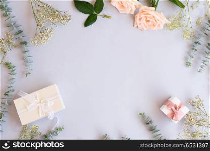 gift or present box and flowers. gift or present box and flowers on blue table from above, flat lay frame