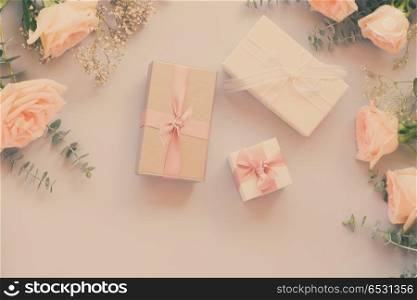 gift or present box and flowers on blue table from above, retro toned. gift or present box and flowers. gift or present box and flowers
