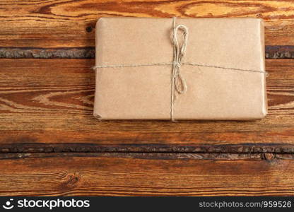 gift Packed in eco-friendly biodegradable cardboard on dark old wooden background with blank space for text. top view. flat lay