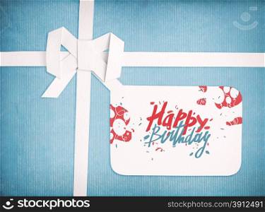 Gift ribbon and bow with Happy birthday lettering on gift tag