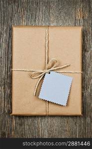 Gift with tag in brown paper