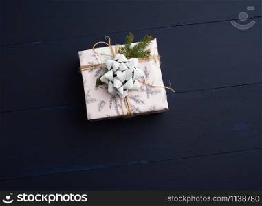 gift wrapped in colored paper on a blue wooden background, festive backdrop, top view, copy space
