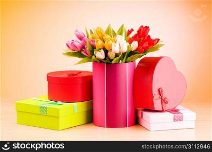 Giftbox and tulips against gradient background