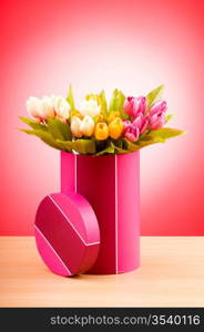 Giftbox and tulips against gradient background