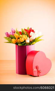 Giftbox and tulips against gradient background