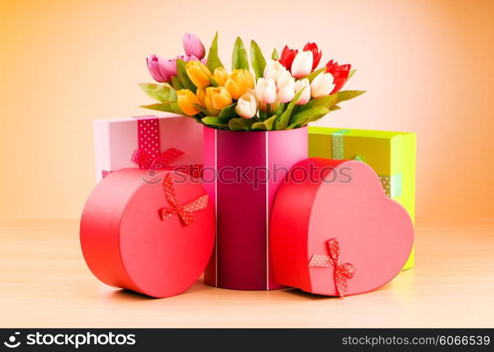 Giftbox and tulips against gradient background