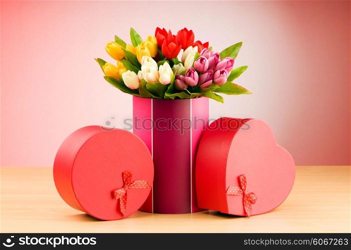 Giftbox and tulips against gradient background