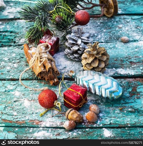 Gifts and decorations for Christmas on wooden background strewn