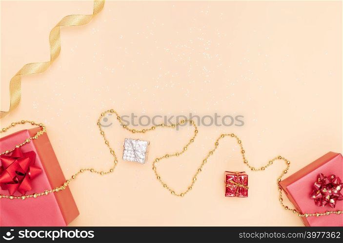 gifts boxes or presents boxes with red bows, star and ball on golden background for birthday, christmas or wedding ceremony