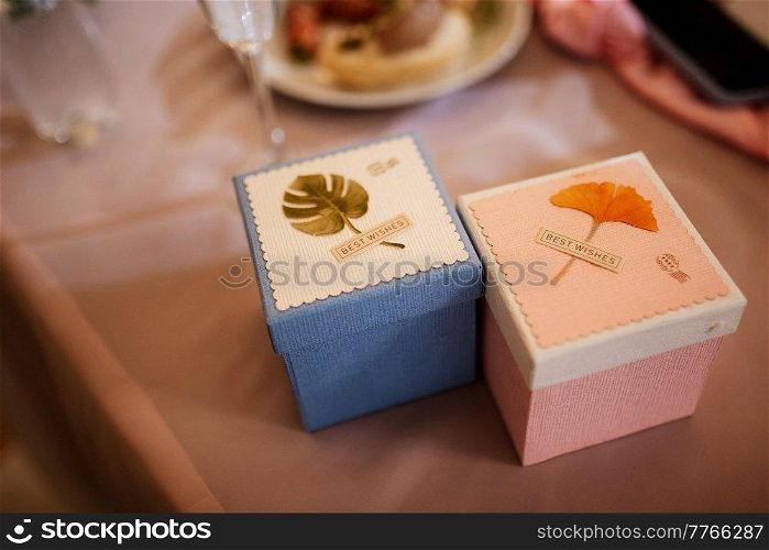 gifts in the hands of a girl in white boxes with ribbons