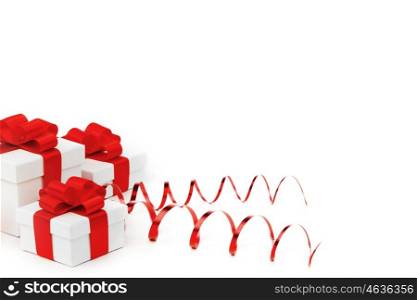 Gifts in white boxes with curly red ribbons isolated on white background