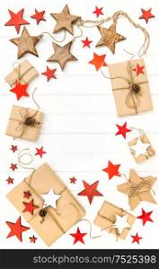 Gifts with christmas decoration and stars on bright wooden background. Flat lay