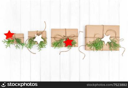 Gifts with christmas decoration on bright wooden background