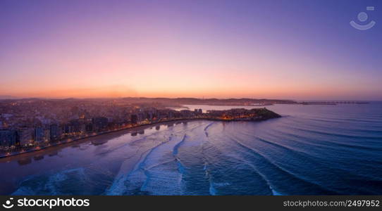 Gijon Xixon downtown and San Lorenzo beach aerial drone panorama at twilight. Gijon or Xixon is the biggest city in Asturias, Spain.